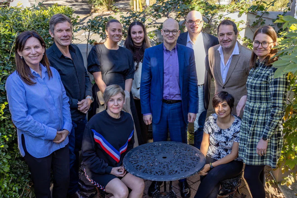 The MindSkiller® team gathered outdoors around a table.