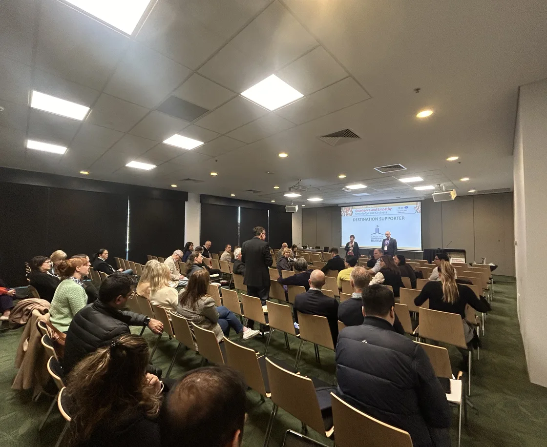 Delegates seated in a conference room during a MindSkiller presentation
