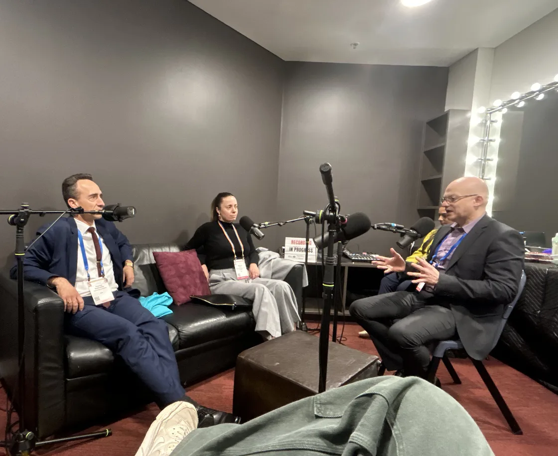 Three specialists recording a podcast interview at a mental-health conference