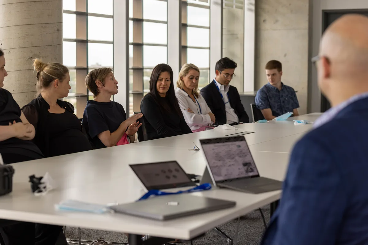 A care team collaborating around a meeting table