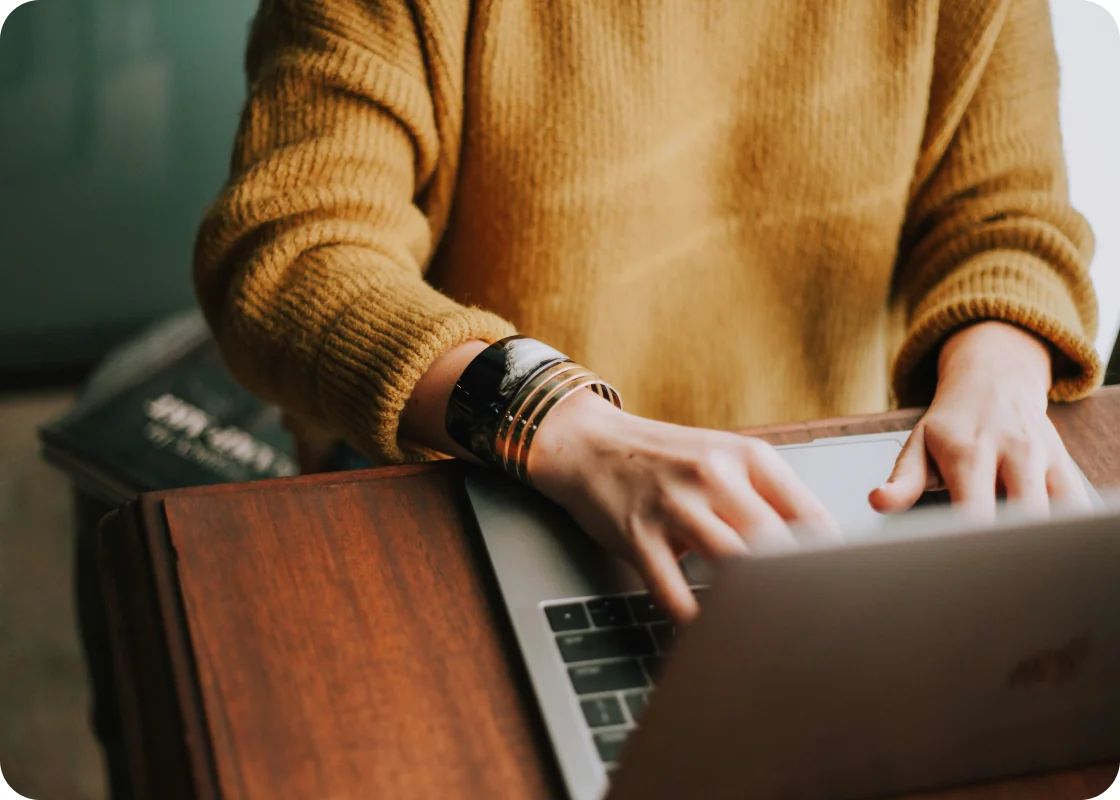 A clinician reviewing care on a laptop
